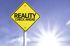 Reality Check Ahead road sign with sun background .jpeg